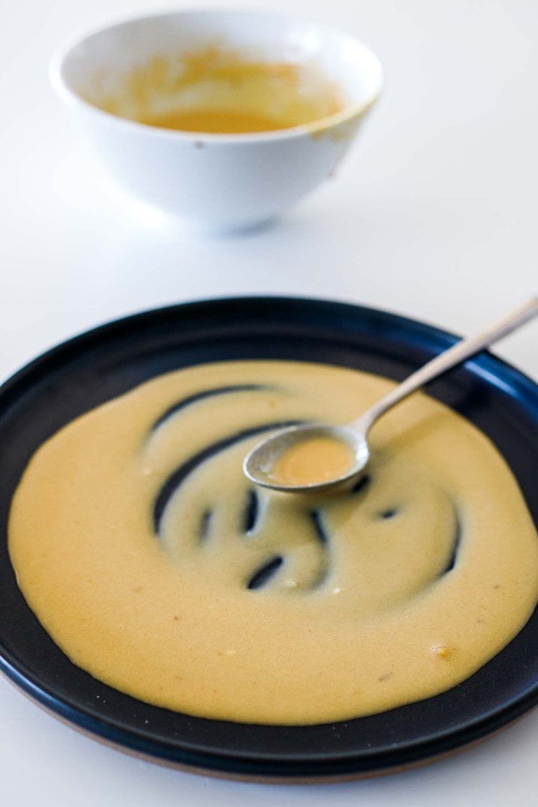 Maple Tahini Sauce being spread on a platter