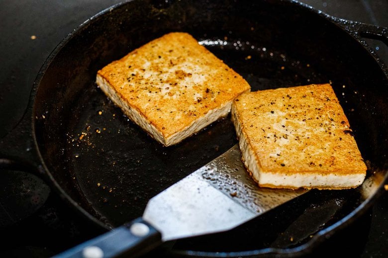 crispy tofu, frying in a skillet