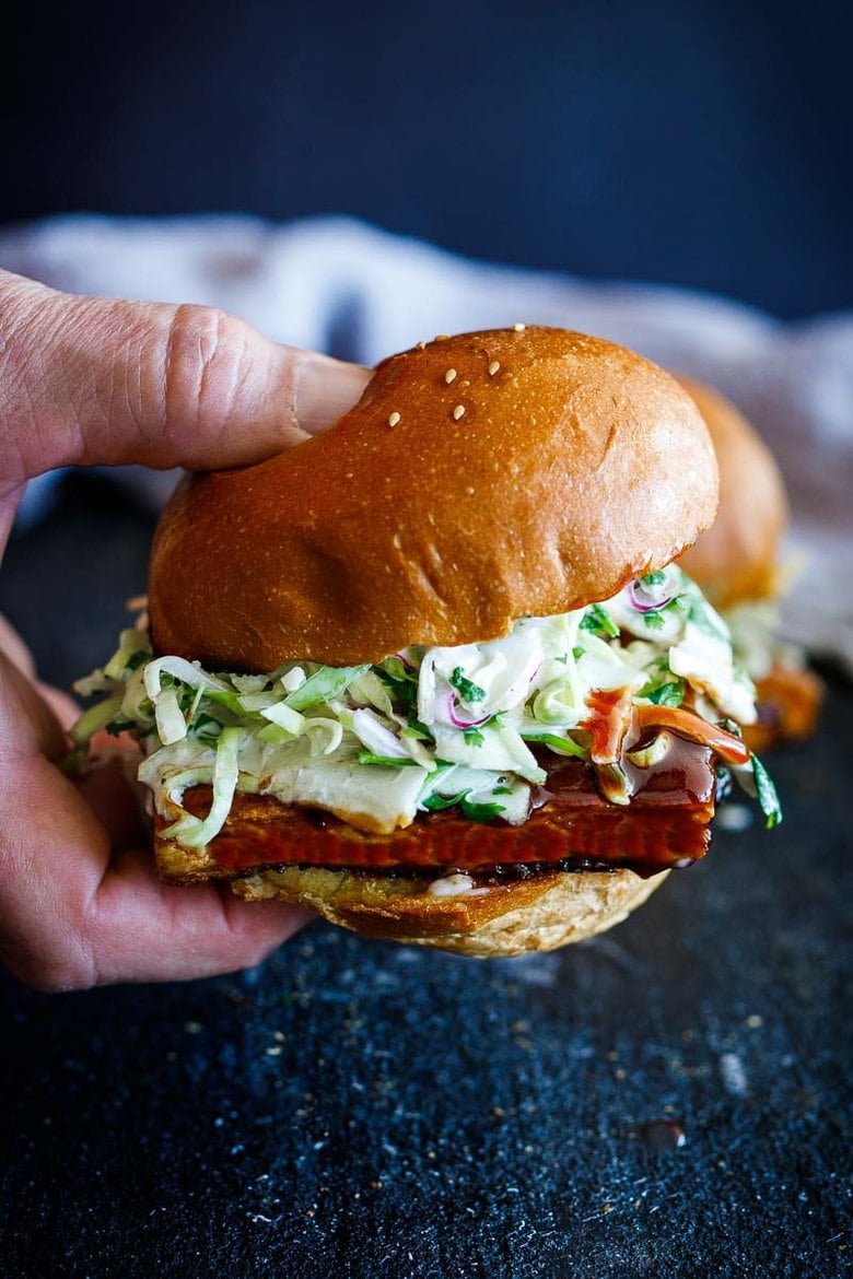 Here's the tastiest recipe for a crispy BBQ Tofu Sandwich topped with cool and creamy cilantro cabbage slaw, that can be made in under 30 minutes - plus it is vegan.