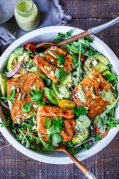 The BEST Grilled Salmon Salad with Avocado, Arugula, Cucumber, Pepitas, Cotija Cheese & Creamy Cilantro Lime Dressing-perfect for summer barbecues and outdoor gatherings. Chock full of fresh organic produce, not only is this entree salad healthy and easy to make, it's bursting with delicious summertime flavor! Keto and Low-carb.