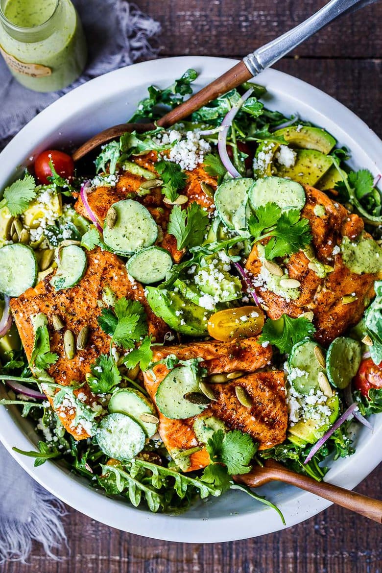 The BEST Grilled Salmon Salad with Avocado, Arugula, Cucumber, Pepitas, Cotija Cheese & Creamy Cilantro Lime Dressing-perfect for summer barbecues and outdoor gatherings. Chock full of fresh organic produce, not only is this entree salad healthy and easy to make, it's bursting with delicious summertime flavor! Keto and Low-carb.