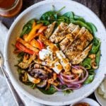 This spinach salad is a twist on the classic with deeply flavored with grilled mushrooms, red onions, sweet peppers and herby grilled chicken. Topped with our flavorful take on a healthy French style dressing. A perfect complete dinner for warm days.