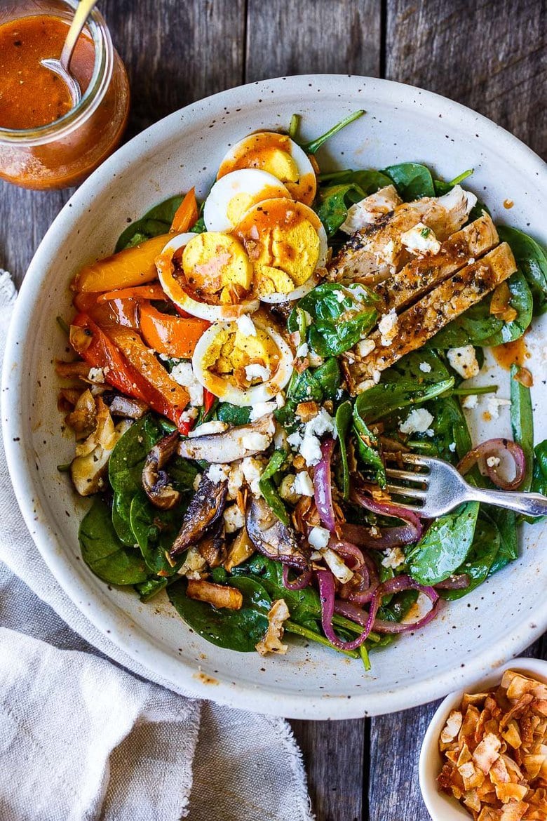 Delicious & healthy Spinach Salad with grilled mushrooms, red onions, sweet peppers and herby grilled chicken, tossed with French Dressing.