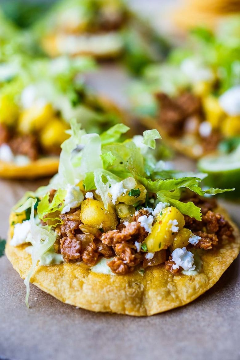  Chipotle Tostadas are crunchy, fresh and easy to make.  Simple homemade tostada shells are slathered with avocado cream, then piled with savory ground meat (turkey, chicken or plant-based) and topped with fresh pineapple salsa.  Vegan-adaptable. 