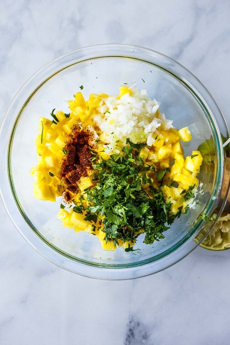 mixing together pineapple salsa