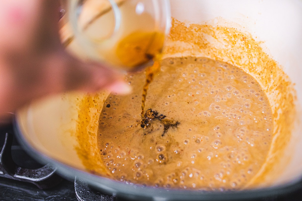 adding fish sauce to the pot