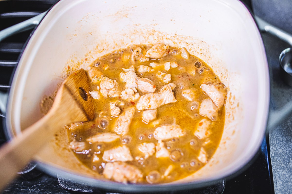 adding chicken to the pot