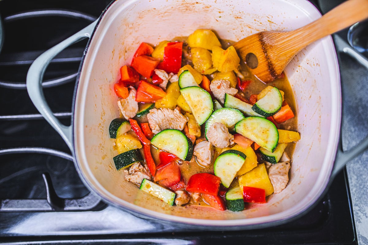 adding veggies to the pot