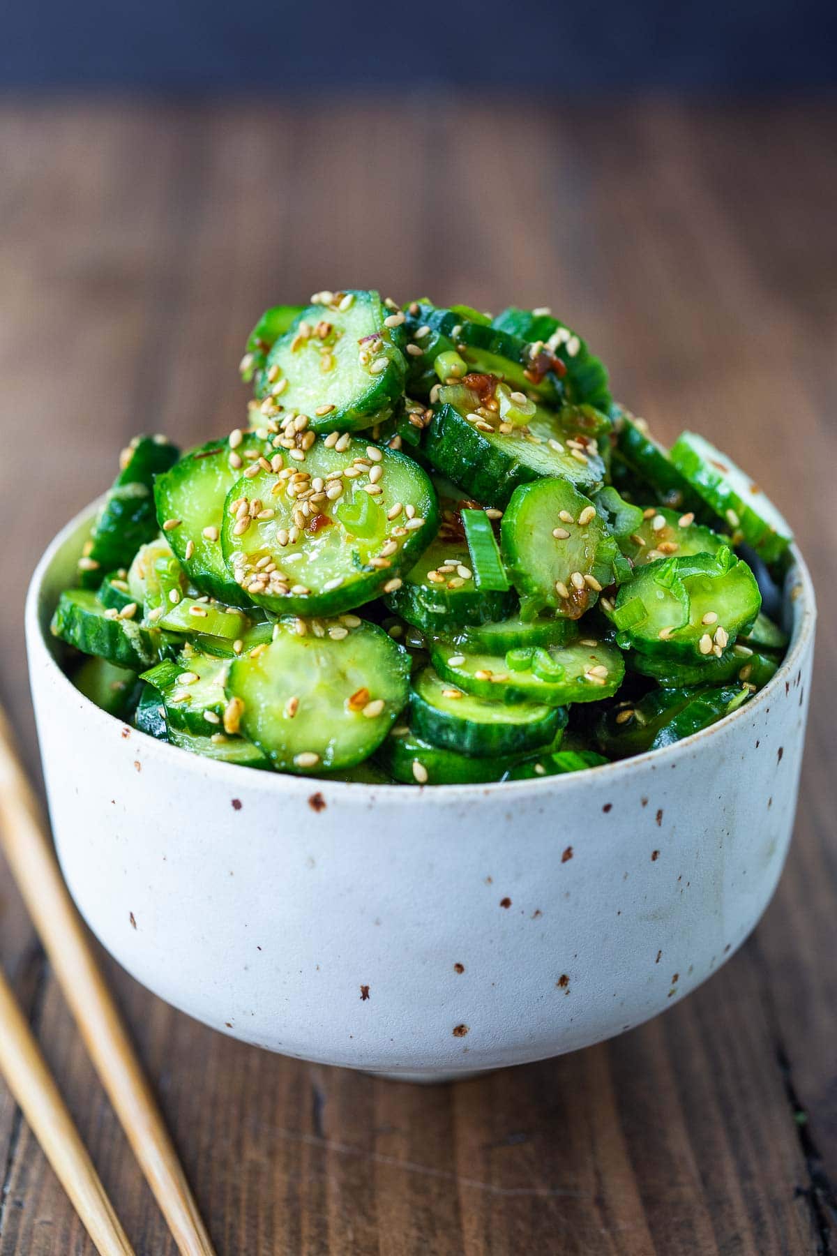 Asian cucumber salad in a white bowl- our best cucumber recipe!