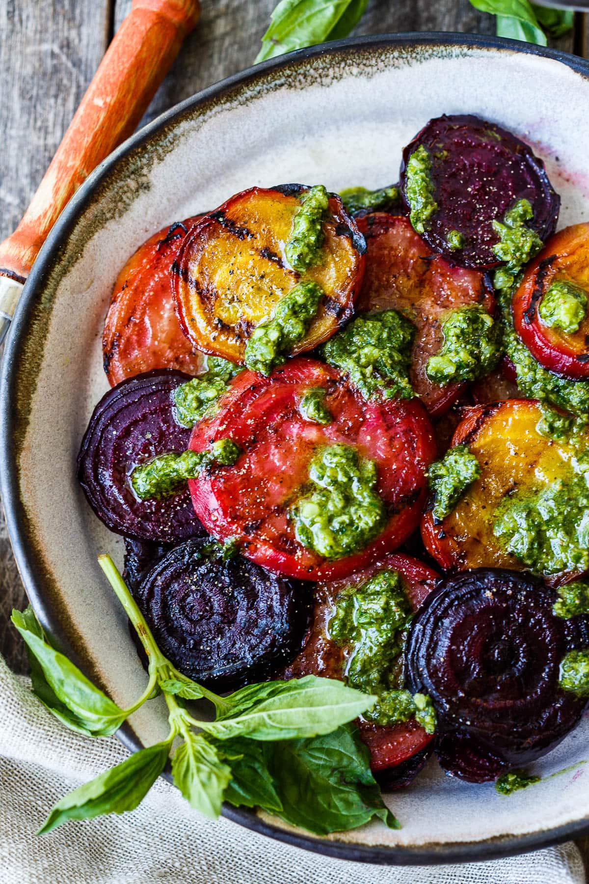 Grilled beets are full of incredible flavor! Here's how to make the most delicious beets, roasted then grilled, topped with basil pesto. 