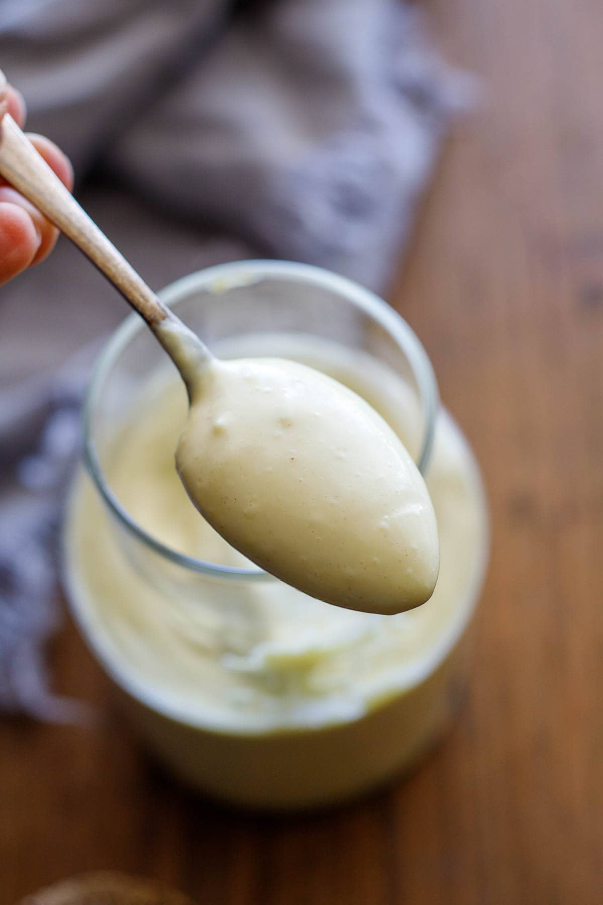 a spoonful of creamy olive oil mayo in jar