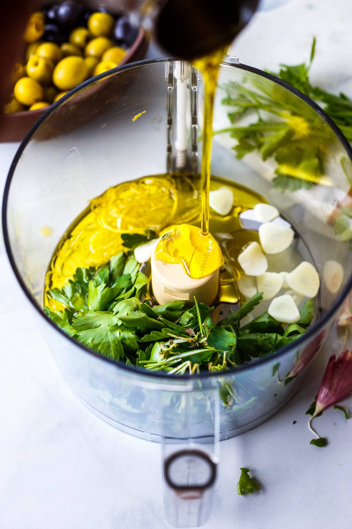 adding the ingredients to the food processor