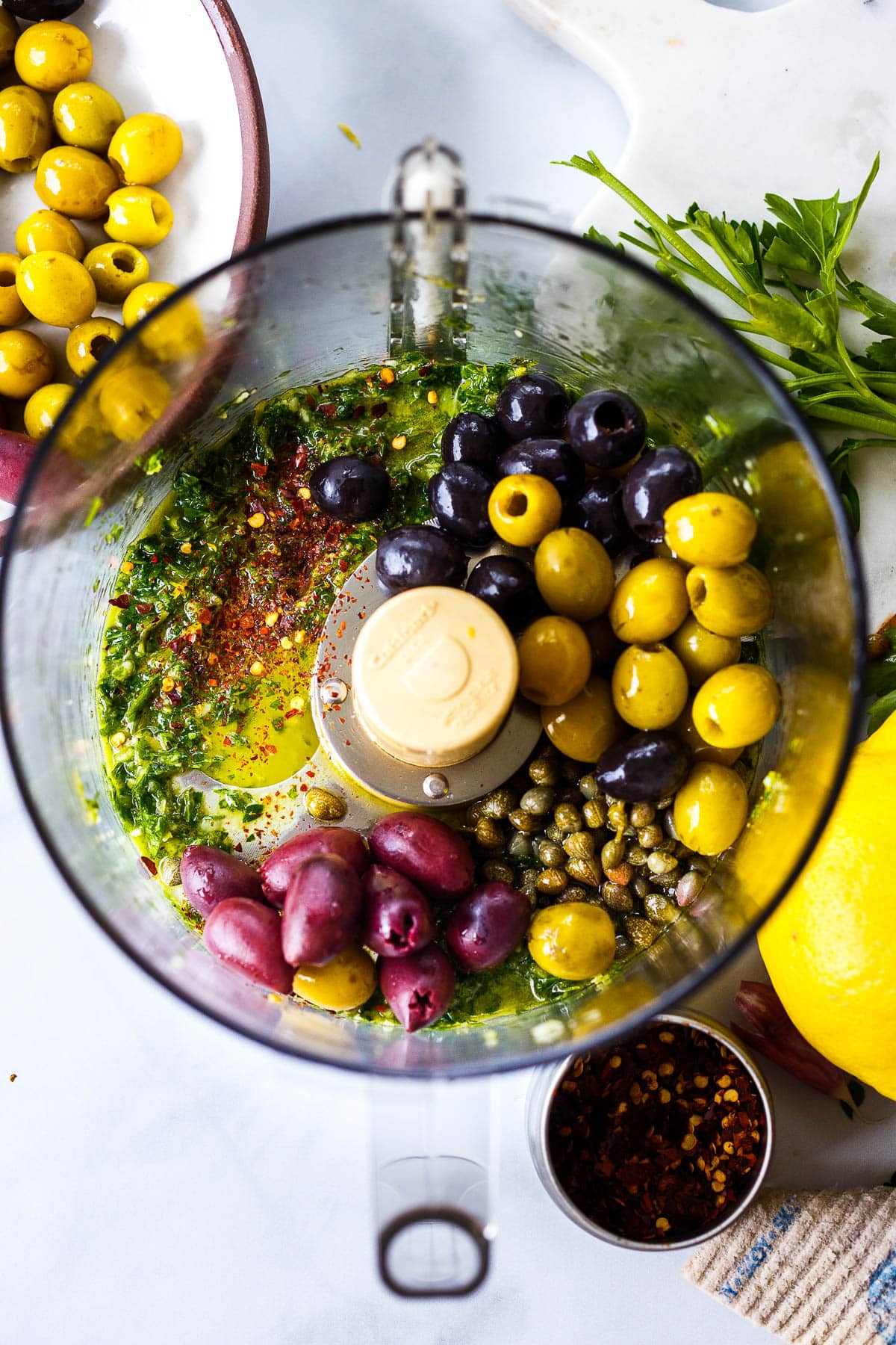 making olive tapenade in the food processor