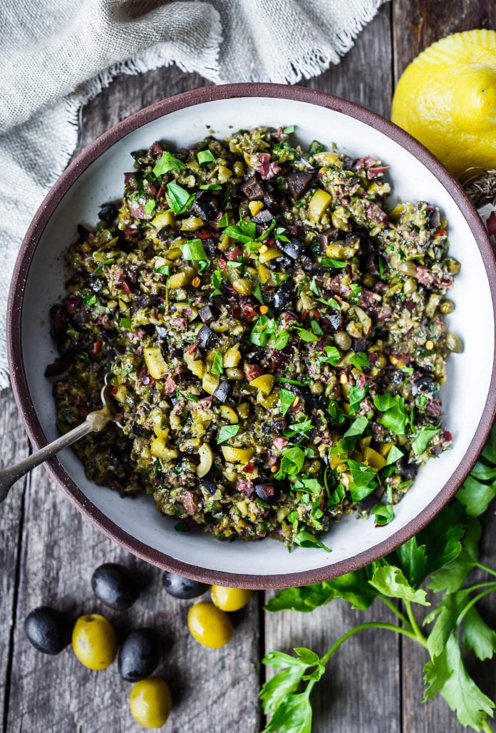 Versatile and full of flavor, Olive Tapenade is a simple, elegant addition to your appetizer list.  This tasty spread comes together fast and requires no cooking, making it a great choice for warm summer days.  