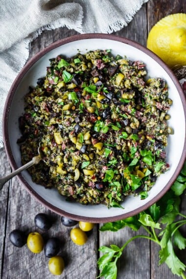 Versatile and full of flavor, Olive Tapenade is a simple, elegant addition to your appetizer list.  This tasty spread comes together fast and requires no cooking, making it a great choice for warm summer days.  