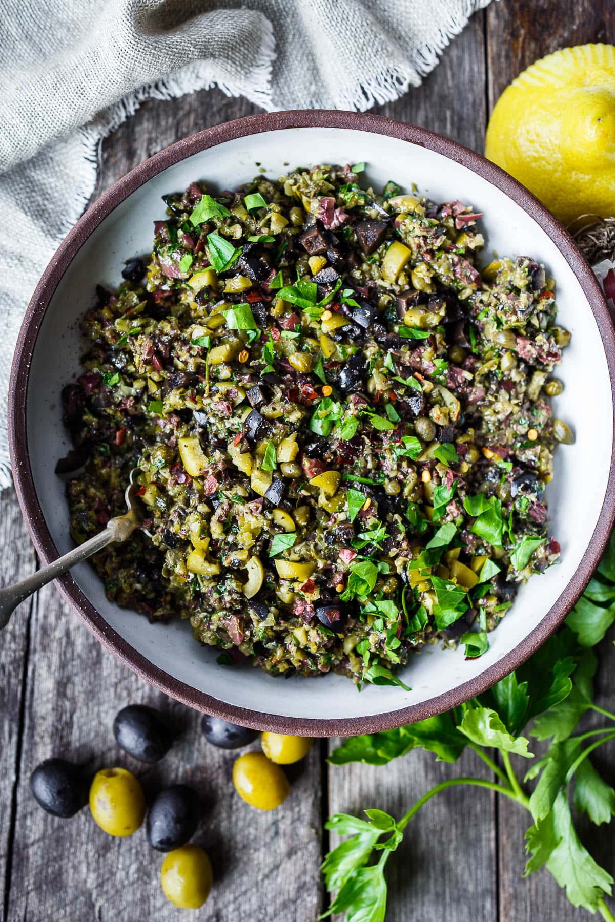 Versatile and full of flavor, Olive Tapenade is a simple, elegant addition to your appetizer list.  This tasty spread comes together fast and requires no cooking, making it a great choice for warm summer days.  