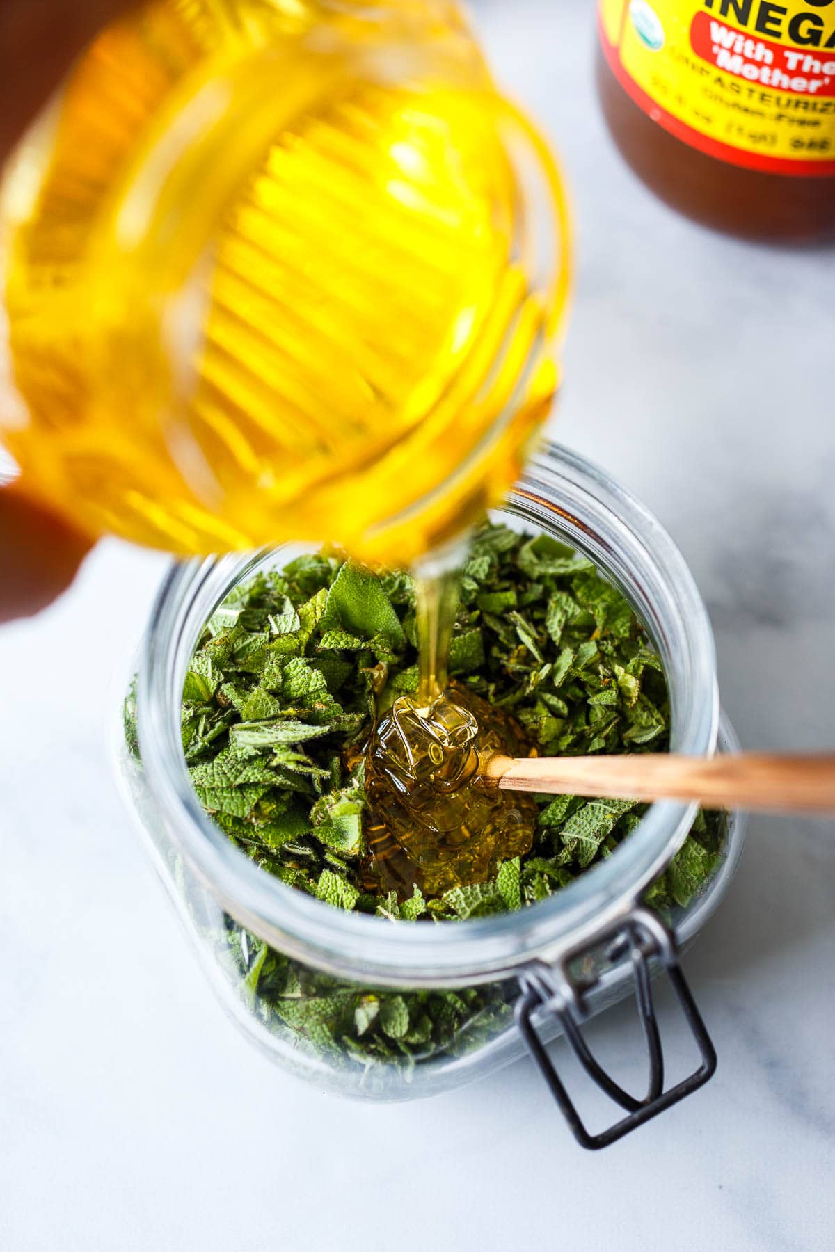 Pouring honey into sage.