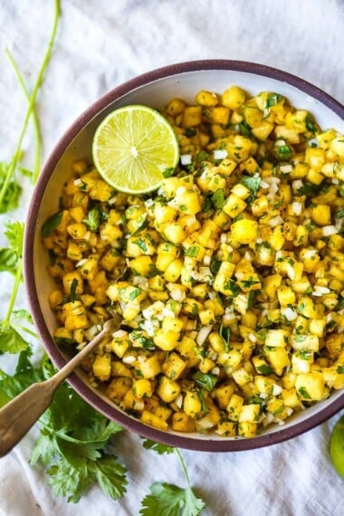 Made with a few simple ingredients, this fresh Pineapple Salsa is perfectly balanced and bursting with juicy delicious flavor!  A delicious complement to tacos and tostadas and burgers, or serve as a refreshing appetizer with tortilla chips. Vegan. 