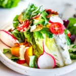 Cool and crisp Wedge Salad made with little gem lettuce, beets, tomatoes, radishes, herbs and coconut bacon, topped with Creamy Gorgonzola dressing.