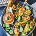 This recipe for Chicken Satay is bursting with authentic Thai flavor! Chicken (or tofu) is bathed in a fragrant marinade of coconut milk and Thai spices, then grilled to perfection and served with a flavorful peanut dipping sauce.  Vegan-adaptable!