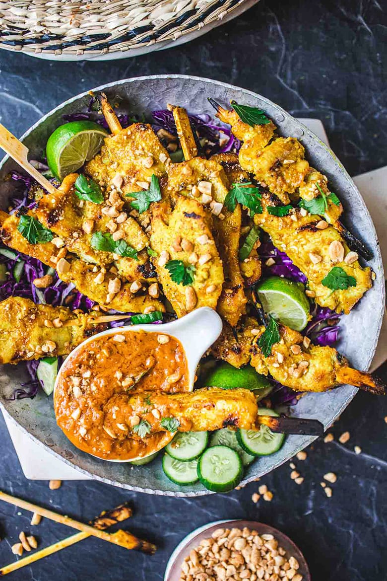 This recipe for Chicken Satay is bursting with authentic Thai flavor! Chicken (or tofu) is bathed in a fragrant marinade of coconut milk and Thai spices, then grilled to perfection and served with a flavorful peanut dipping sauce.  Vegan-adaptable!