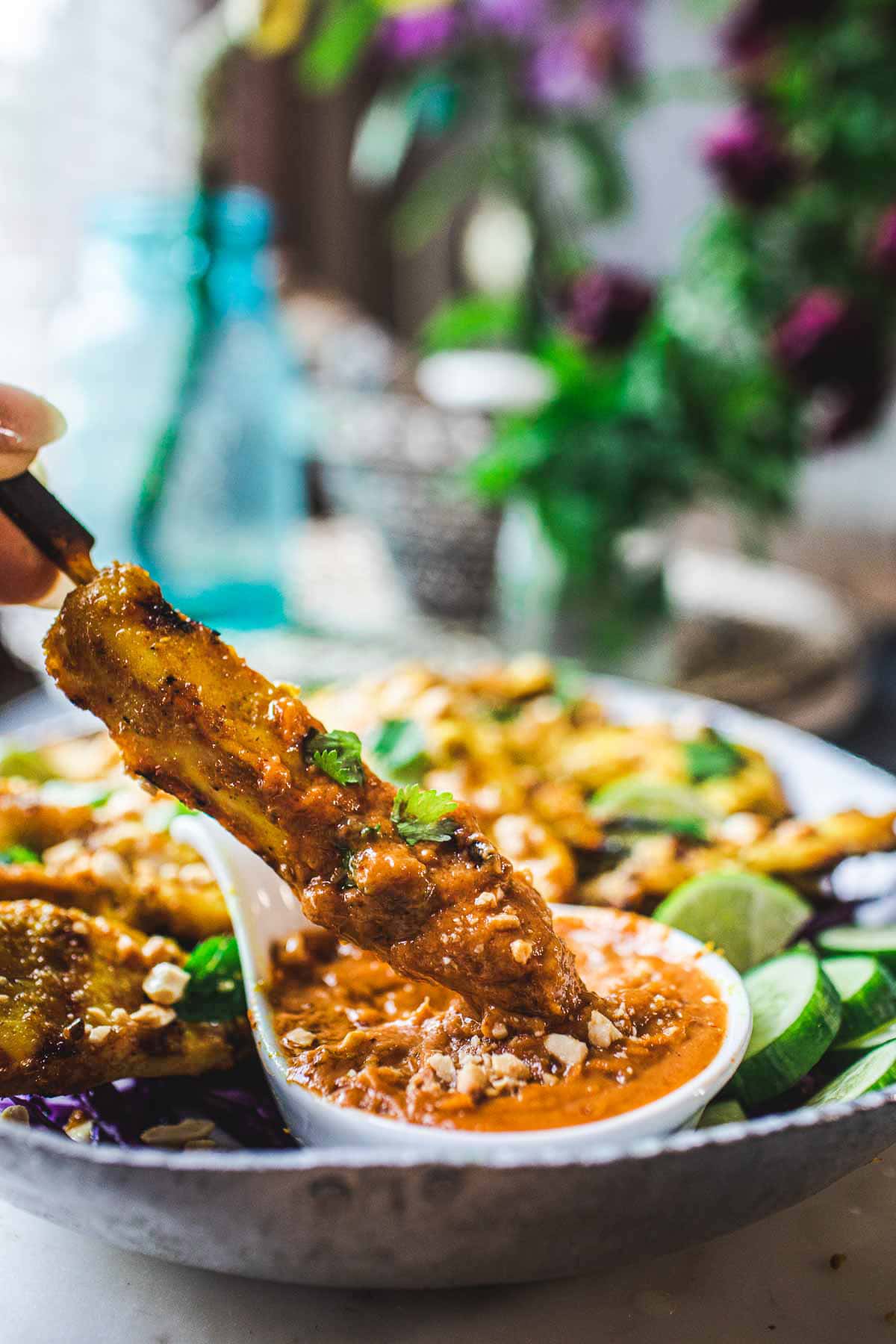This recipe for Chicken Satay is bursting with authentic Thai flavor! Chicken (or tofu) is bathed in a fragrant marinade of coconut milk and Thai spices, then grilled to perfection and served with a flavorful peanut dipping sauce.  Vegan-adaptable!