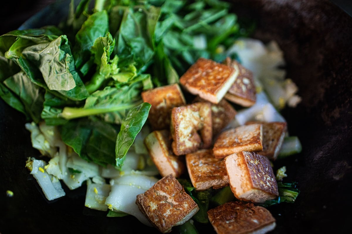 chinese broccoli and crispy tofu in a wok