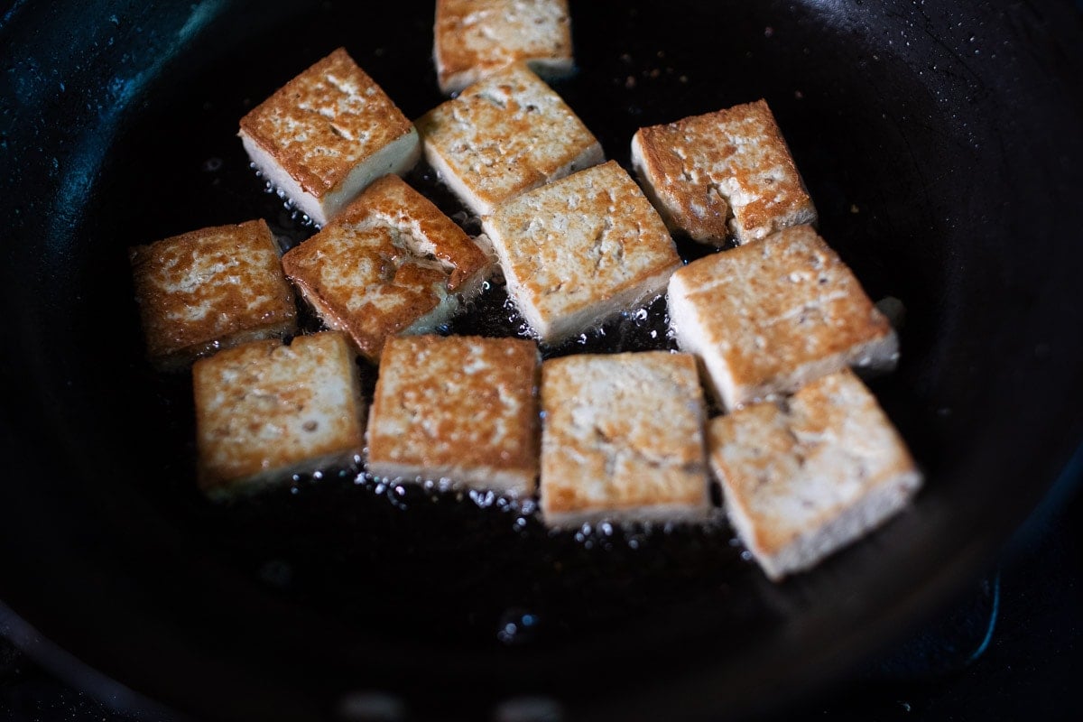 frying crispy tofu in a pan