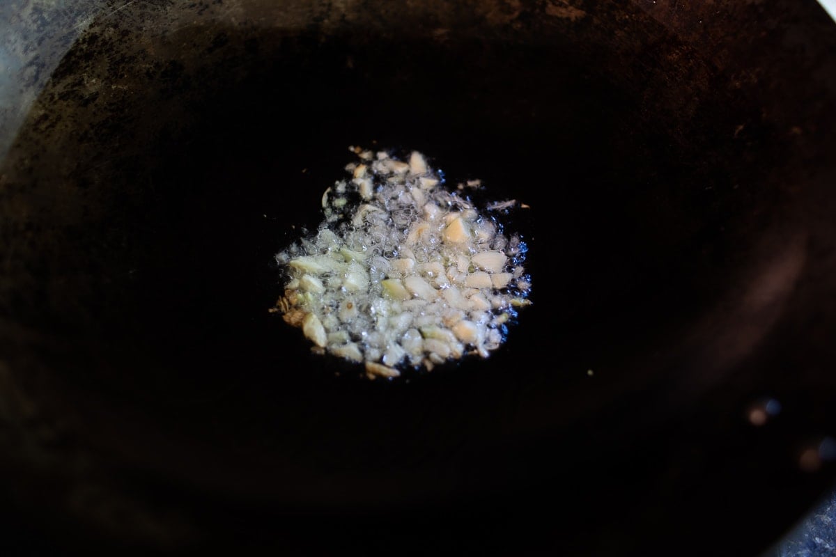 garlic fried in oil in a wok