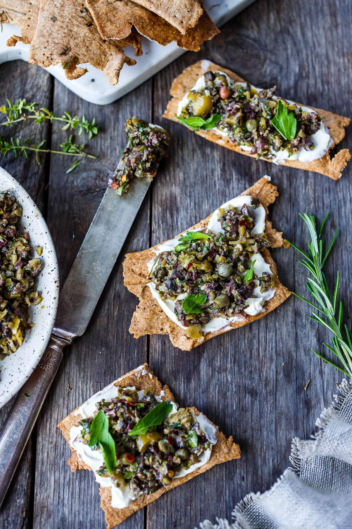 Versatile and full of flavor, Olive Tapenade is a simple, elegant addition to your appetizer list.  This tasty spread comes together fast and requires no cooking, making it a great choice for warm summer days.  