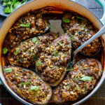 This Stuffed Eggplant recipe is so cozy and warming! Succulent eggplant is filled with basmati rice, your choice of ground meat (or lentils), herbs, and Lebanese spices and baked until meltingly tender, in a fragrant tomato broth. Vegan-adaptable.