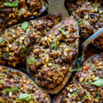 Succulent Stuffed Eggplant infused with Lebanese spices, baked in the oven until meltingly tender. Filled with basmati rice, your choice of ground meat (or lentils) herbs, and pine nuts in a fragrant tomato broth. Vegan-adaptable.