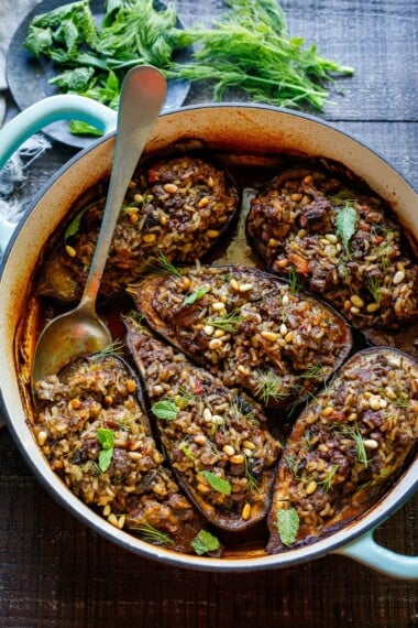 This Stuffed Eggplant recipe is so cozy and warming! Succulent eggplant is filled with basmati rice, your choice of ground meat (or lentils), herbs, and Lebanese spices and baked until meltingly tender, in a fragrant tomato broth. Vegan-adaptable.