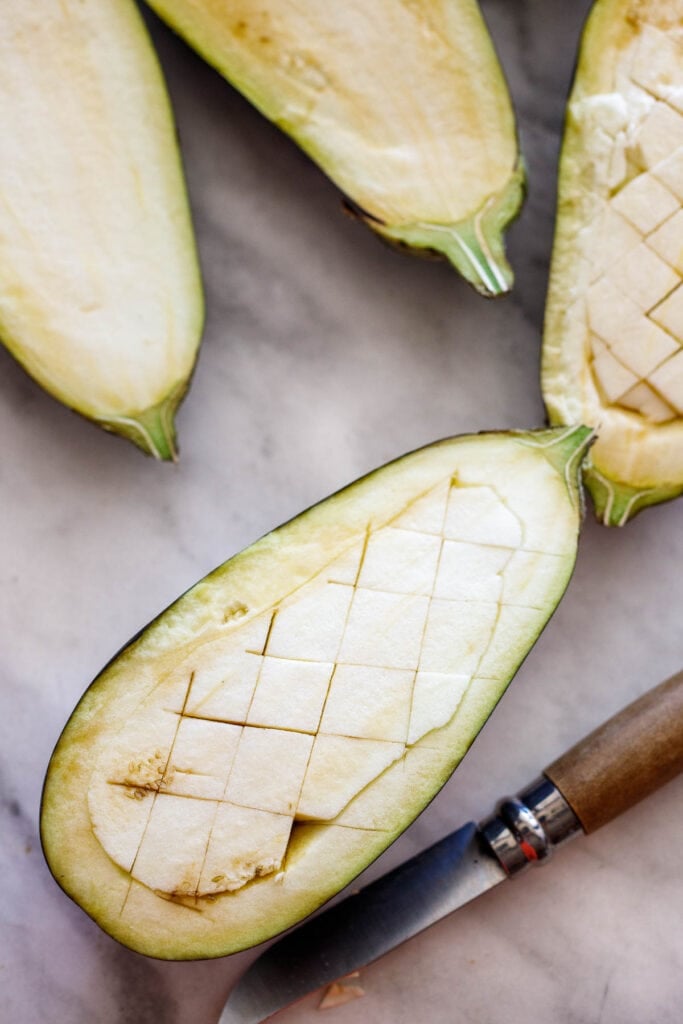 Eggplant cut in a cross hatch.