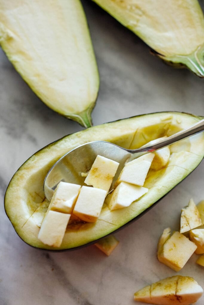 Scooping out eggplant cubes.