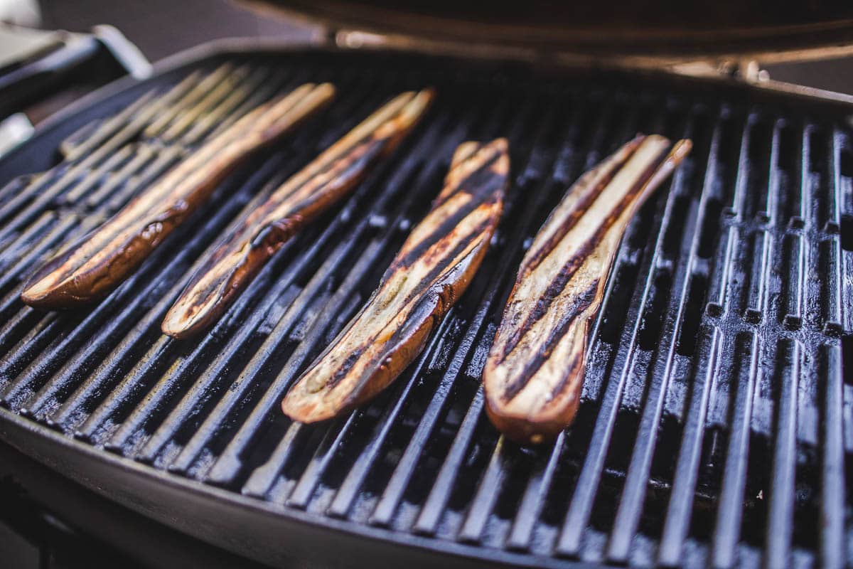 4 long eggplants on a grill