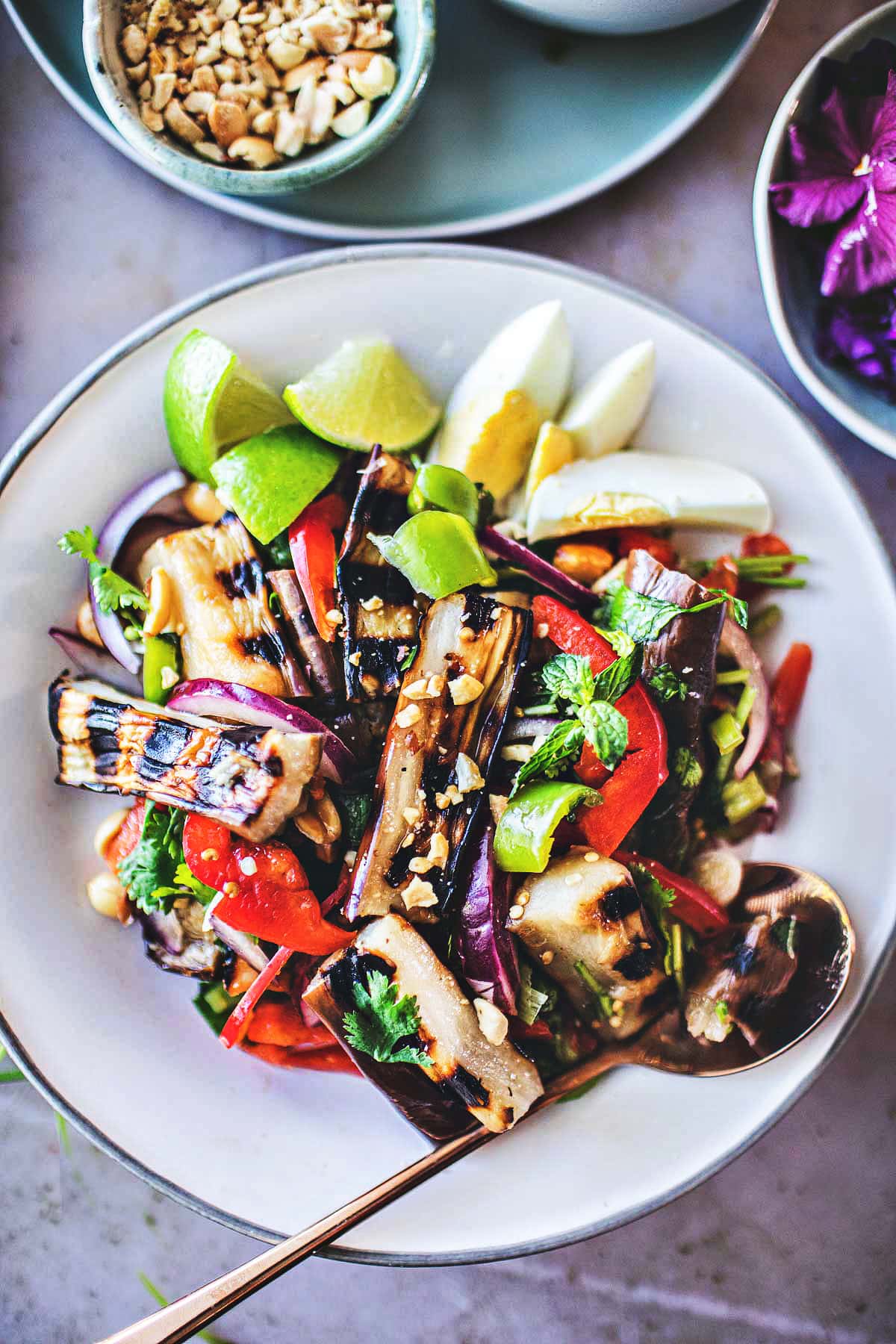 This flavorful Thai Grilled Eggplant Salad is simple, light, and refreshing with a tangy, umami dressing made from fresh lime juice and fish sauce. Healthy and tasty, this Thai Salad comes together in 35 minutes! (Vegan-adaptable) Serve it with jasmine rice and make it a meal.