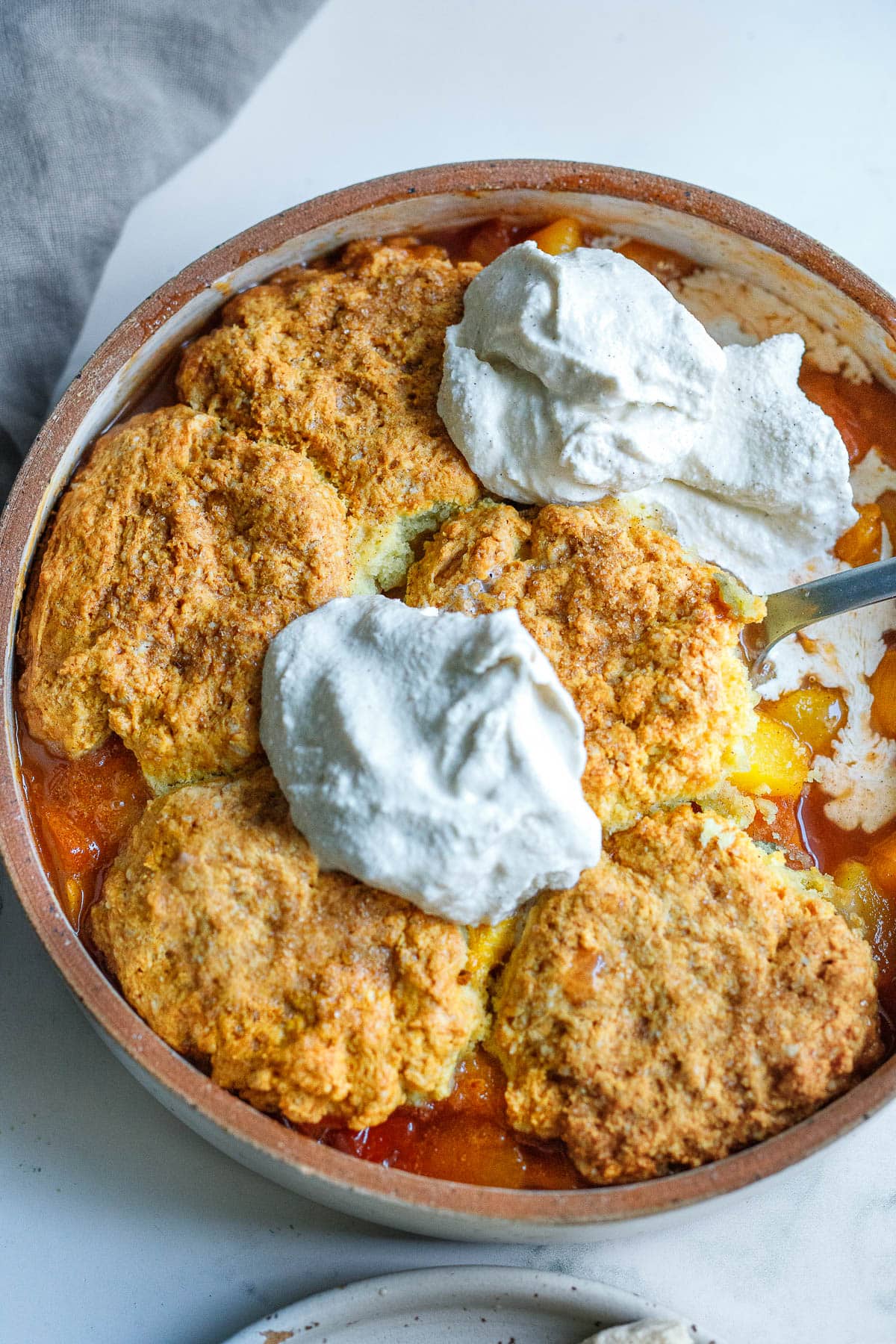 This recipe for Peach Cobbler is simple and easy, and allows the glorious flavor of summer peaches to shine through. With just 30 minutes of hands-on time before baking in the oven, this is easily one of our "go-to" summer desserts.