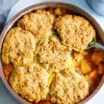 This recipe for Peach Cobbler is simple and easy, and allows the glorious flavor of summer peaches to shine through. With just 30 minutes of hands-on time before baking in the oven, this is easily one of our "go-to" summer desserts.