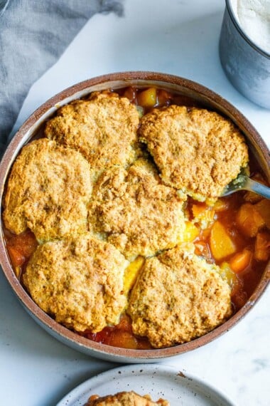 This recipe for Peach Cobbler is simple and easy, and allows the glorious flavor of summer peaches to shine through. With just 30 minutes of hands-on time before baking in the oven, this is easily one of our "go-to" summer desserts.