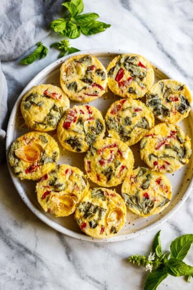 These quick and easy egg bites are the perfect make-ahead breakfast. Make them in 35 minutes, and store them in the fridge for the busy work week, or freeze and reheat. Keto and Vegetarian.