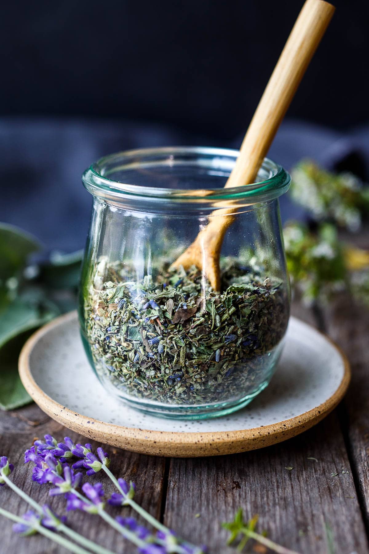 Mixing together dried herbs to create the blend of herbs de Provence.