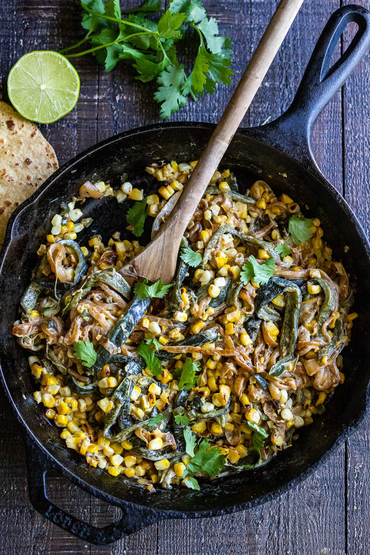 Rajas Tacos are made with strips of poblano peppers, onions and corn, with a hint of Mexican Crema served with cilantro and lime. Vegan-adaptable