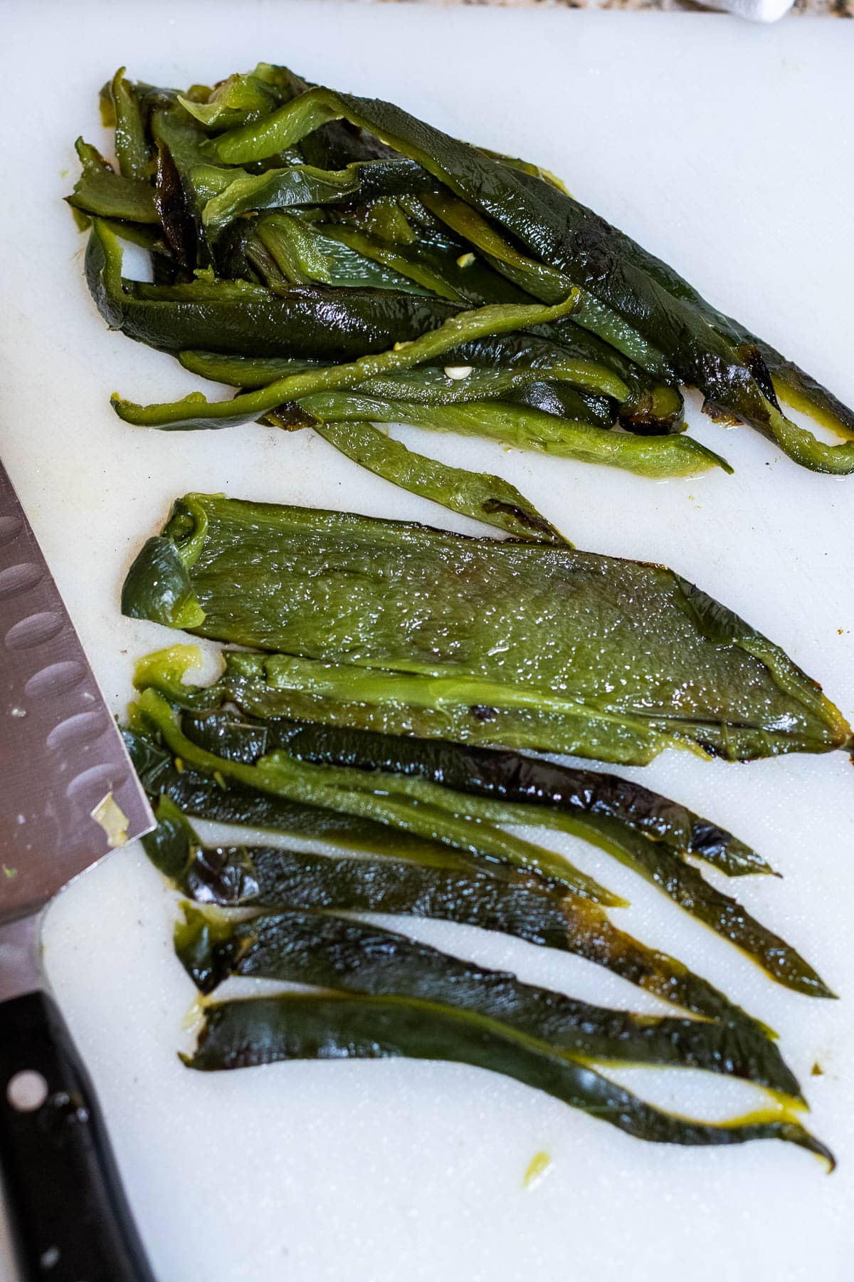 slicing the poblano peppers into strips for rajas