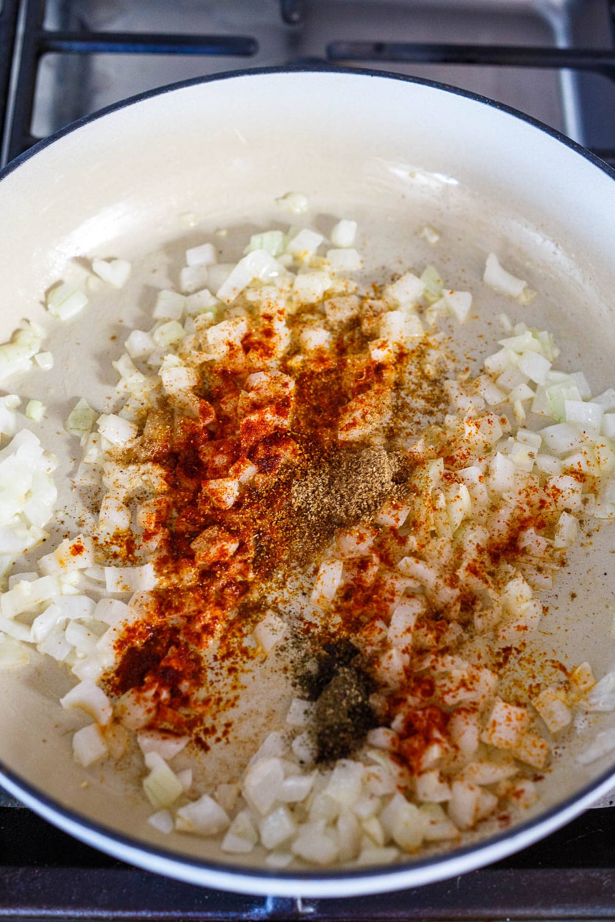 Adding spices to the onions.