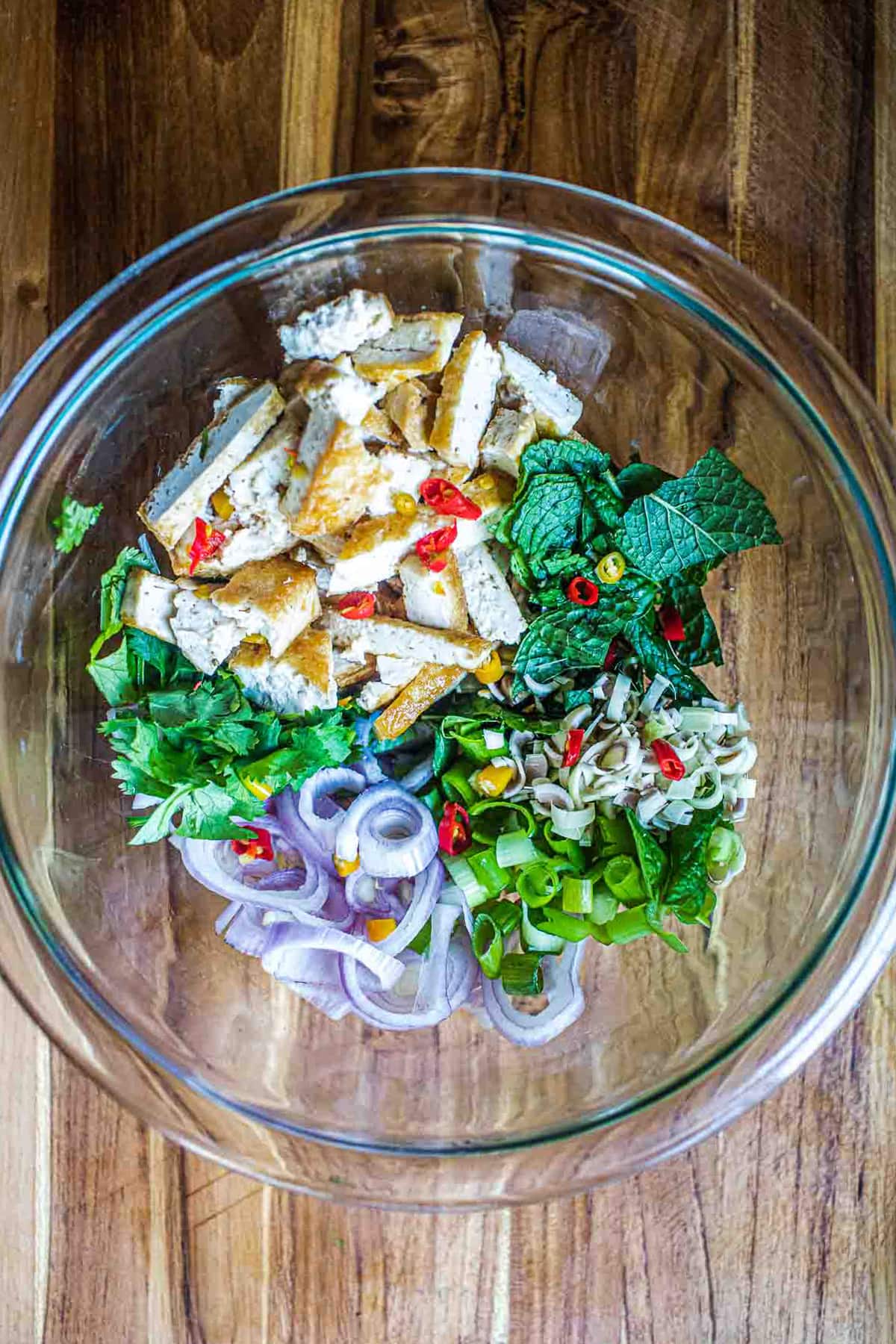 Tofu and herbs salad in a glass bowl