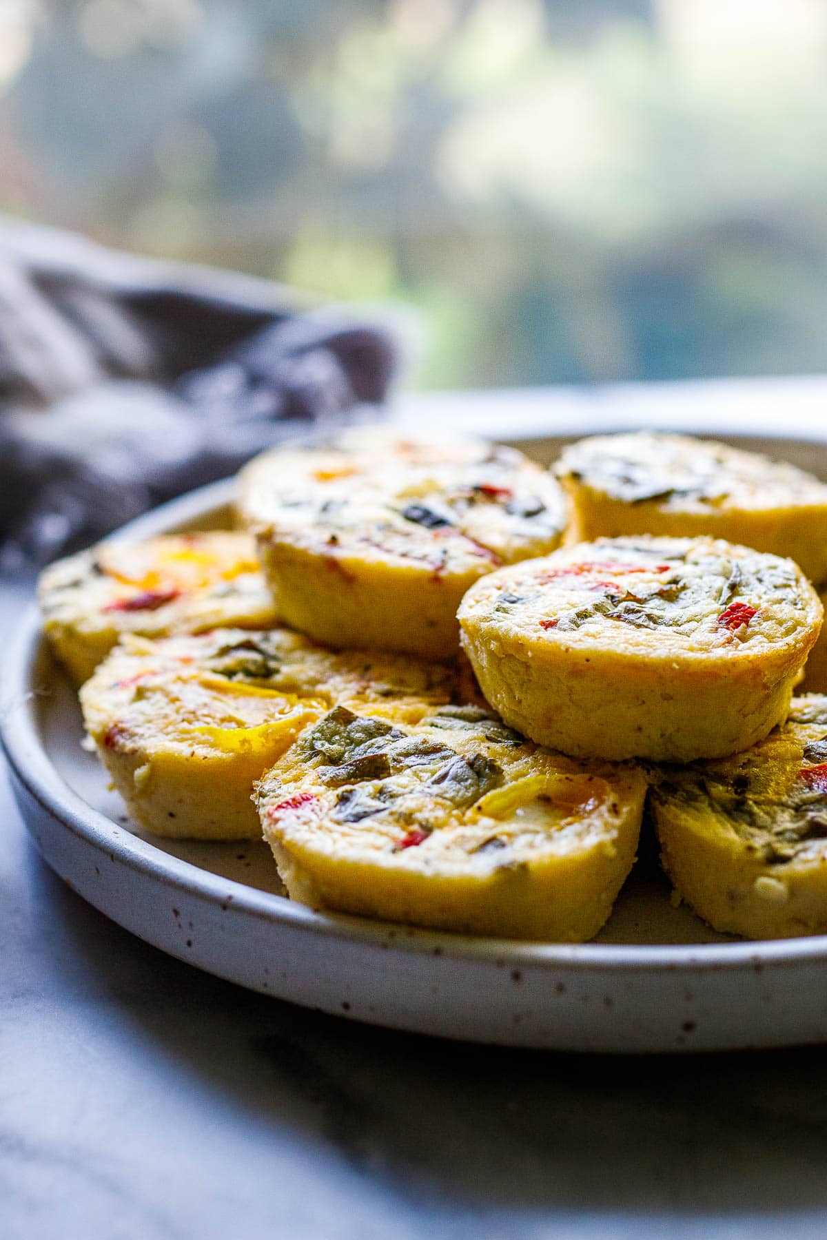 These quick and easy egg bites are the perfect make-ahead breakfast. Make them in 35 minutes, and store them in the fridge for the busy work week, or freeze and reheat. Keto and Vegetarian.