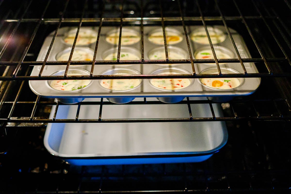 egg bites in the oven with a pan of water underneath to steam them