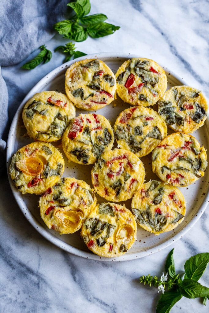 Quick and easy Egg Bites with roasted peppers and basil are the perfect make-ahead breakfast, ready in 35 minutes. Keto, Vegetarian.