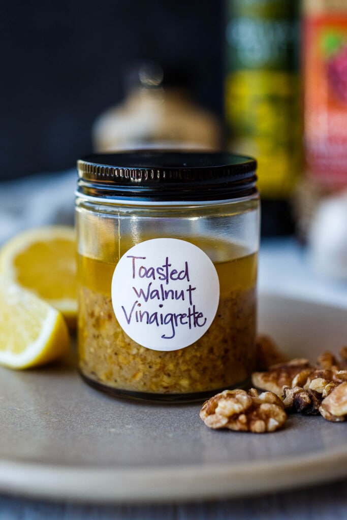 Toasted Walnut vinaigrette in a glass jar with a lid.
